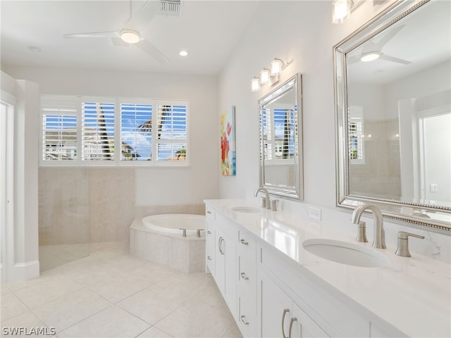 bathroom with tile patterned flooring, vanity, and separate shower and tub