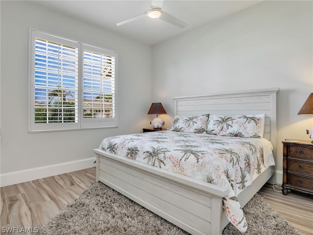 bedroom with light wood-type flooring and ceiling fan