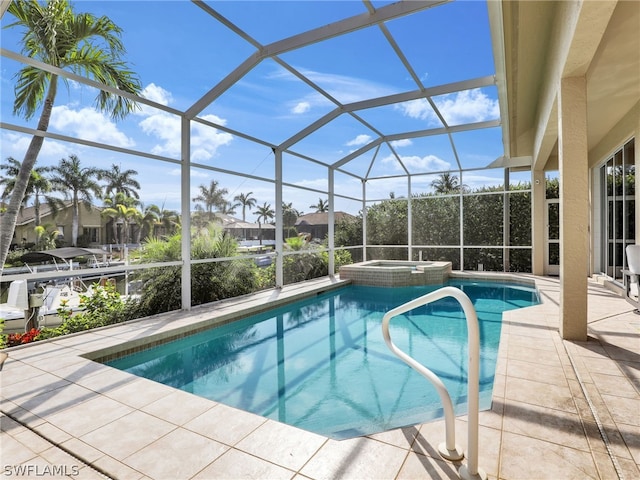 view of swimming pool with a patio, an in ground hot tub, and a lanai