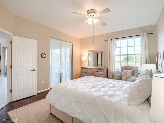 bedroom with ceiling fan and dark hardwood / wood-style flooring