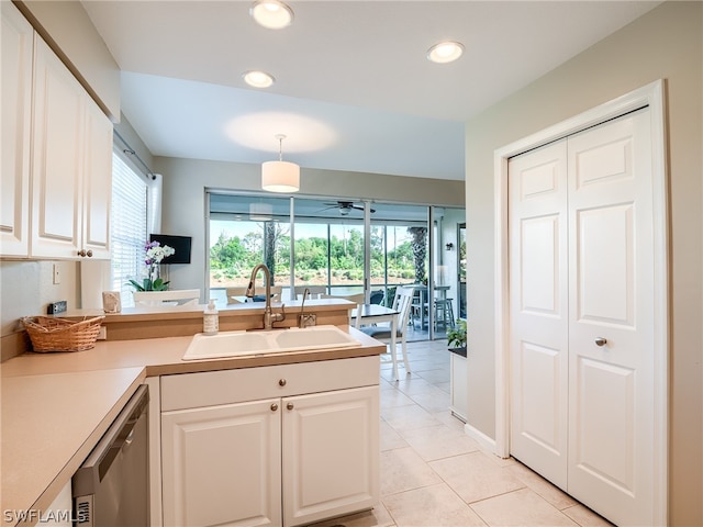 kitchen featuring white cabinetry, ceiling fan, and sink