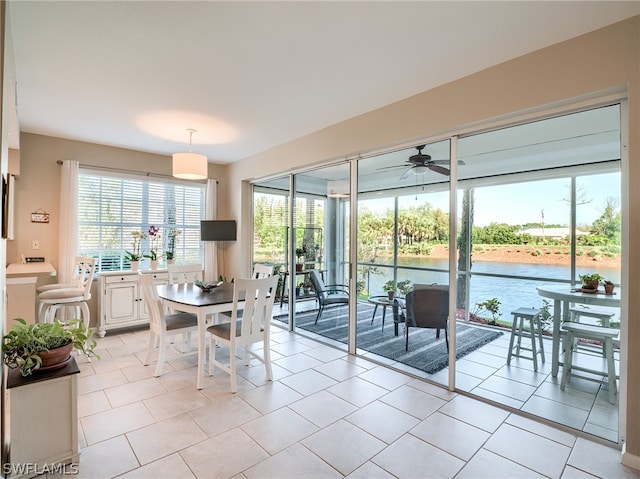 tiled dining room featuring ceiling fan