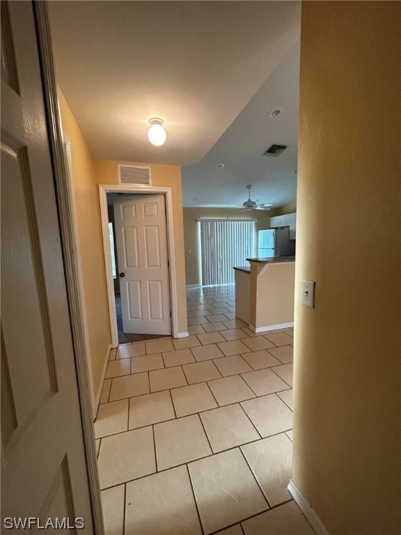 tiled foyer entrance with ceiling fan