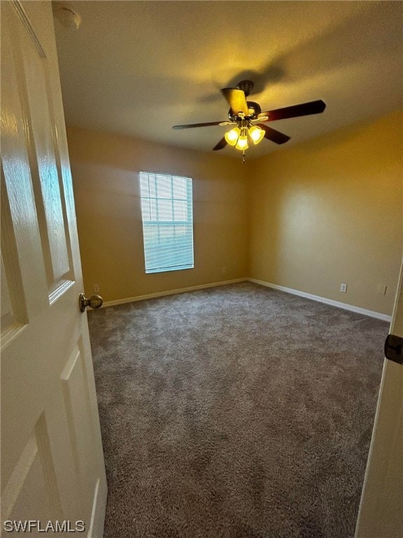 carpeted empty room featuring ceiling fan