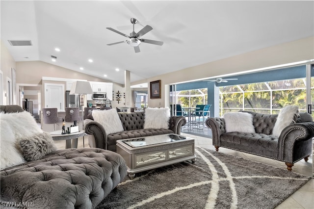 living room featuring lofted ceiling, light tile patterned floors, and ceiling fan