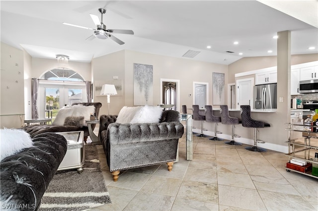 living room featuring lofted ceiling, french doors, and ceiling fan