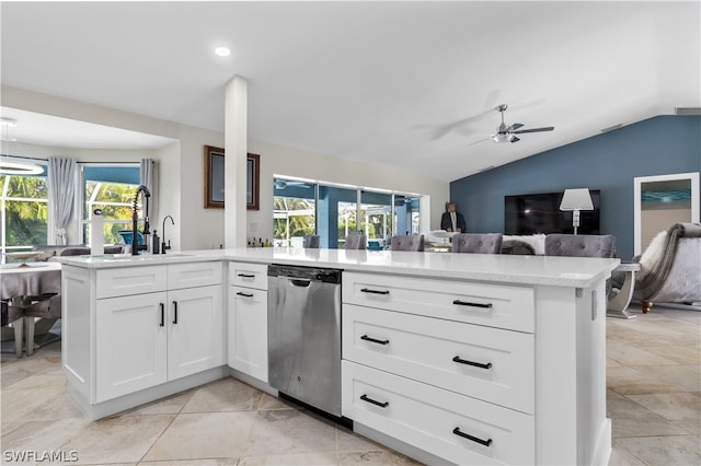 kitchen with white cabinetry, stainless steel dishwasher, lofted ceiling, and ceiling fan