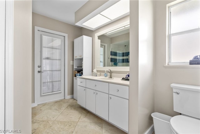 bathroom featuring tile patterned floors, vanity, toilet, and tiled shower