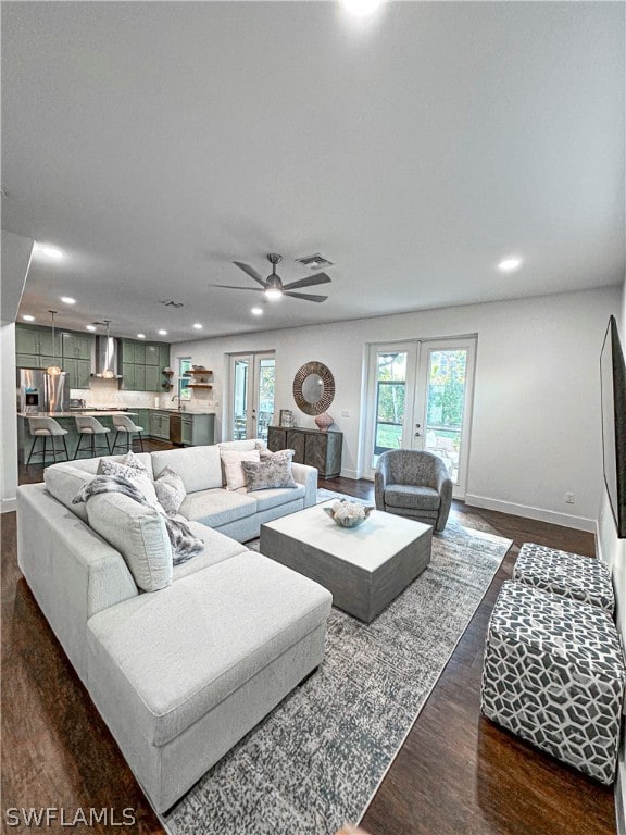 living room featuring ceiling fan, french doors, dark wood-type flooring, and a healthy amount of sunlight