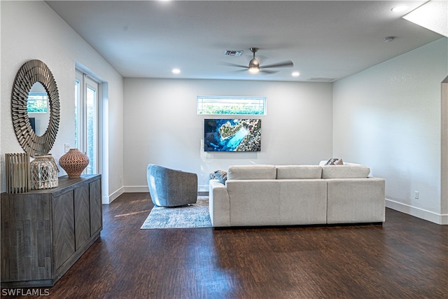 living room with plenty of natural light, ceiling fan, and dark hardwood / wood-style flooring