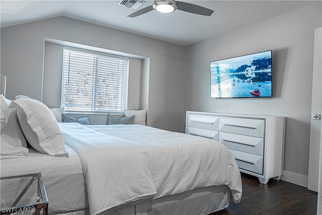 bedroom featuring dark hardwood / wood-style floors, ceiling fan, and vaulted ceiling