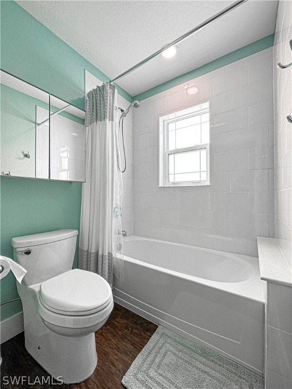 bathroom featuring hardwood / wood-style floors, toilet, a textured ceiling, and shower / bathtub combination with curtain