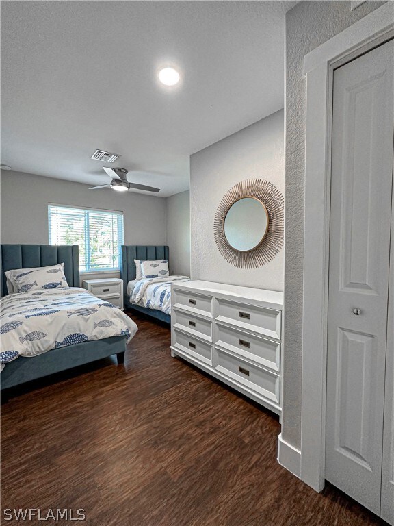 bedroom with ceiling fan and dark wood-type flooring