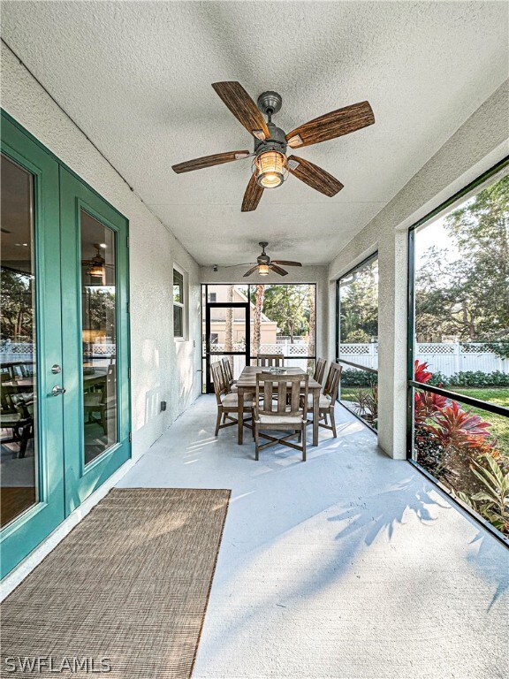 sunroom / solarium featuring ceiling fan