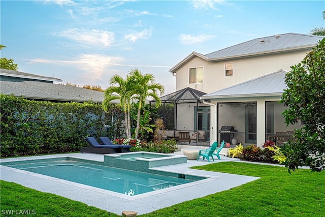 view of swimming pool with a grill, a yard, a patio, and an in ground hot tub