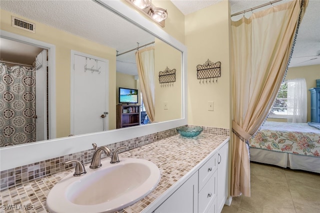 bathroom with tile patterned flooring, connected bathroom, vanity, visible vents, and decorative backsplash