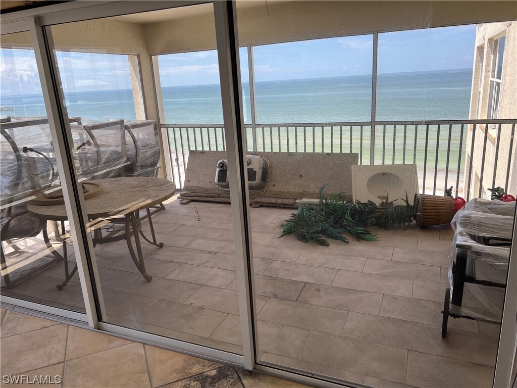 sunroom with a water view and a healthy amount of sunlight