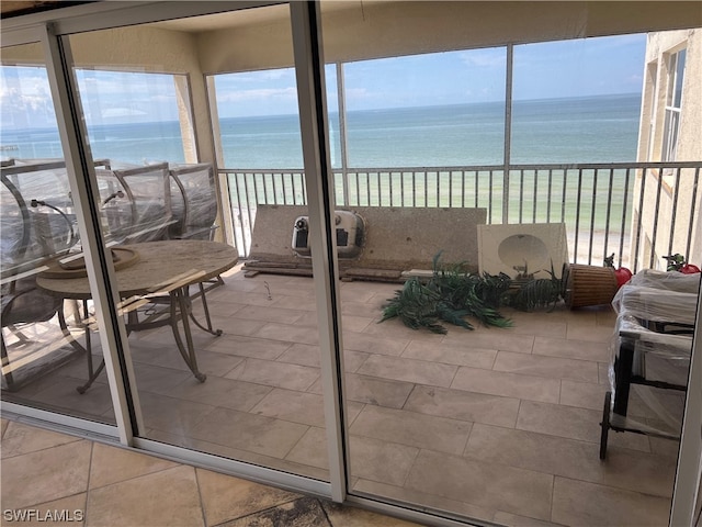 sunroom with a water view and a healthy amount of sunlight