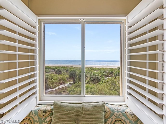 interior space featuring a beach view and a water view