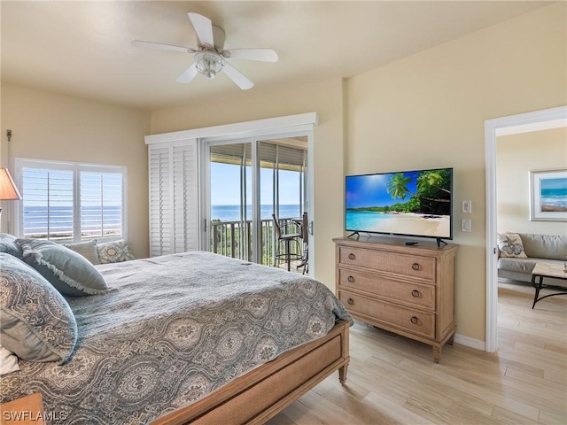 bedroom featuring light wood-type flooring, access to outside, and multiple windows