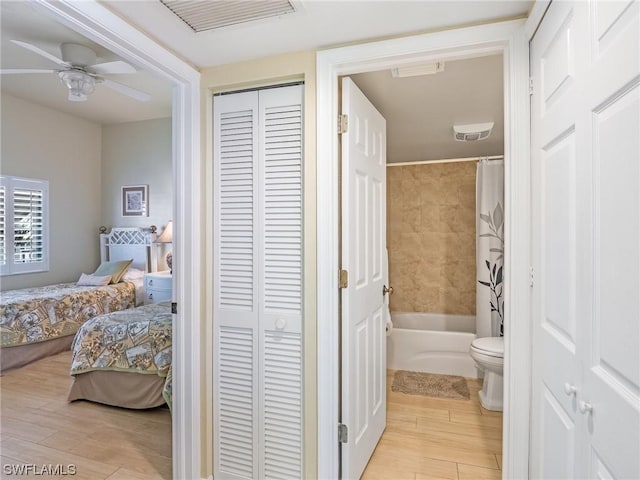 full bath featuring toilet, a closet, wood finished floors, and visible vents