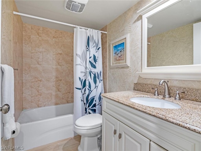 bathroom featuring visible vents, shower / tub combo, vanity, and toilet