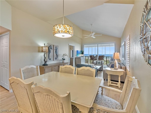 dining room with high vaulted ceiling, ceiling fan, and wood finished floors