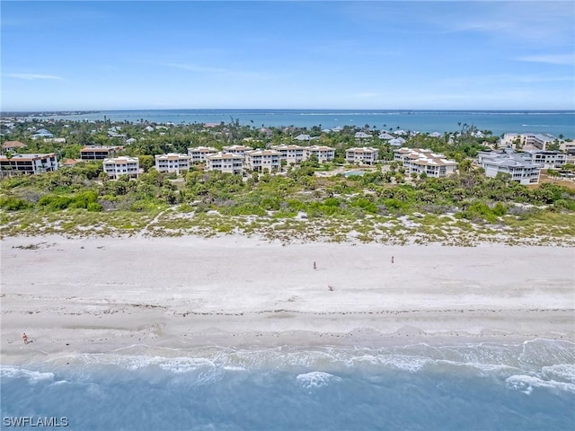 birds eye view of property with a view of the beach and a water view