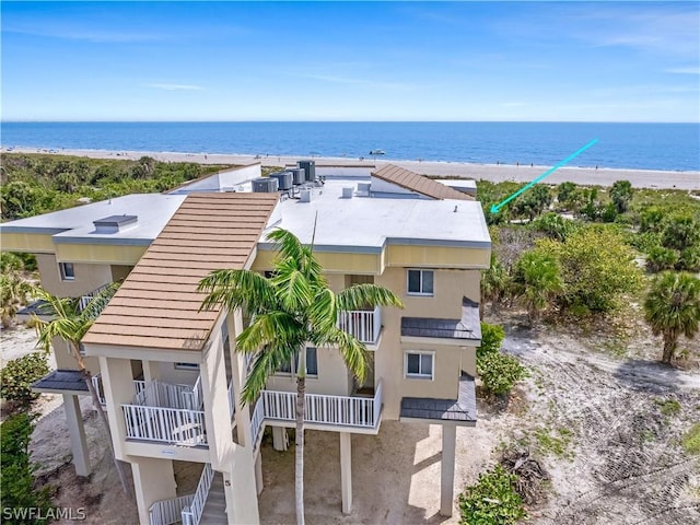 birds eye view of property featuring a water view and a beach view