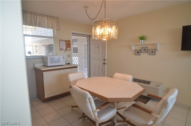 tiled dining room featuring an inviting chandelier