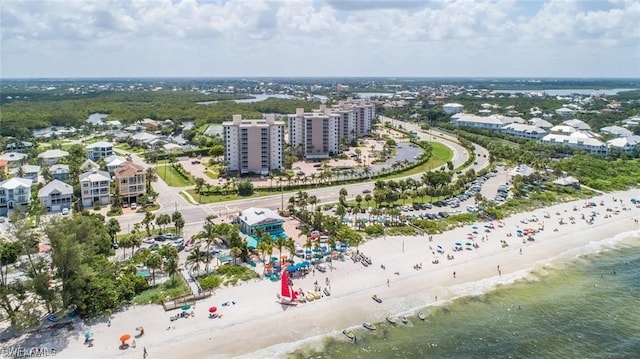 drone / aerial view with a water view and a beach view