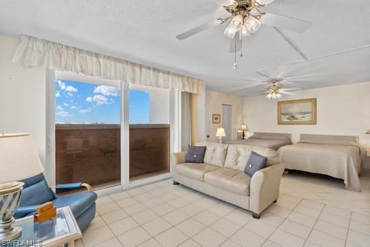 tiled bedroom featuring ceiling fan