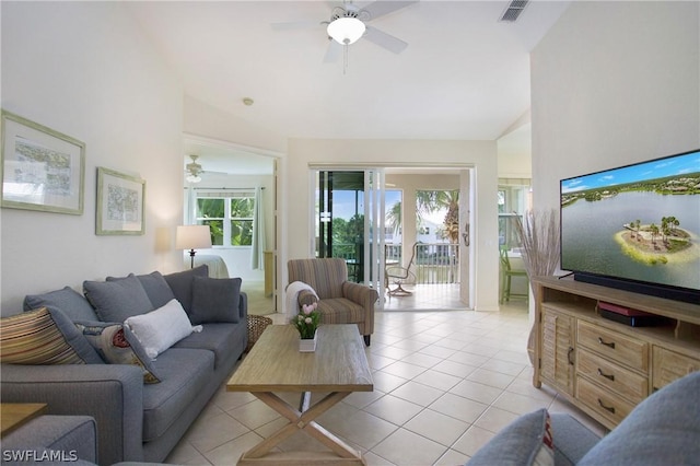 tiled living room with ceiling fan and vaulted ceiling