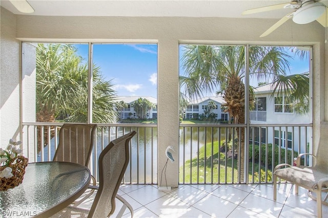 4690 Hawks Nest Way Unit E-204, Naples, FL 34114 - sunroom with a water view, a textured wall, tile patterned floors, and plenty of natural light