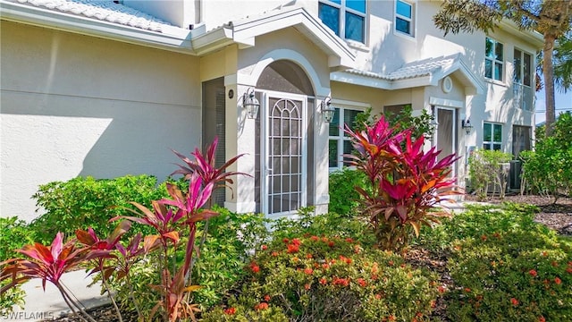 4690 Hawks Nest Way Unit E-204, Naples, FL 34114 - view of exterior entry featuring stucco siding