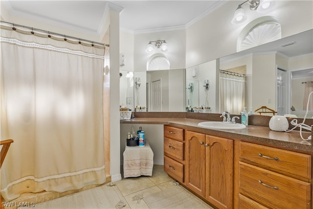 bathroom with vanity with extensive cabinet space, ornamental molding, and tile floors