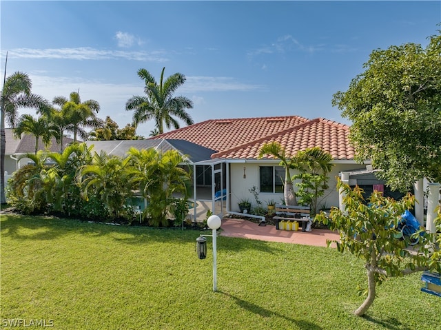 back of property featuring a lawn and a patio