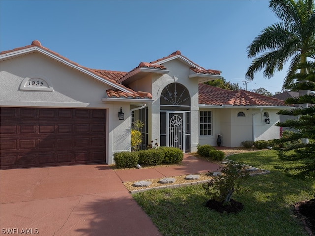 mediterranean / spanish-style house featuring a front yard