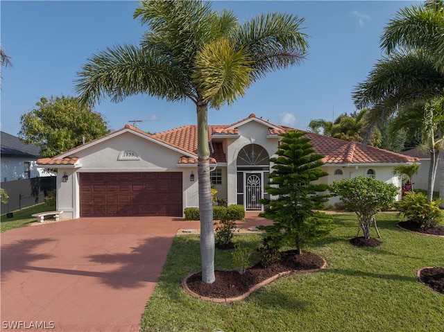 mediterranean / spanish-style home with a front lawn and a garage