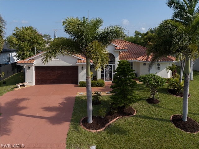 mediterranean / spanish-style home with a front lawn and a garage