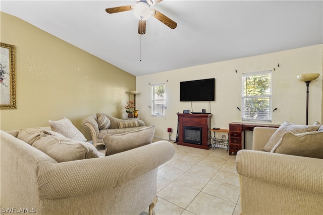 living room featuring light tile flooring, vaulted ceiling, and ceiling fan