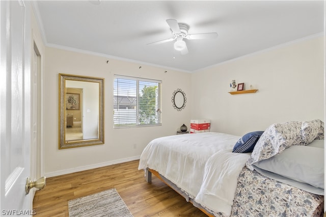 bedroom with ornamental molding, ceiling fan, and light wood-type flooring