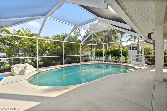 view of swimming pool featuring a lanai and a patio area