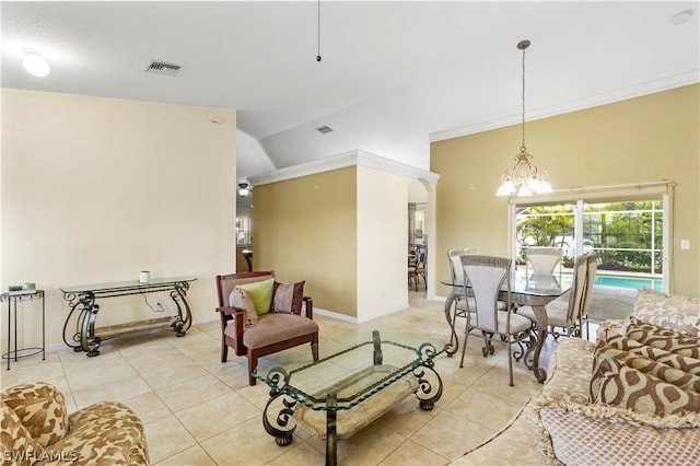 tiled living room with a notable chandelier, a towering ceiling, and ornamental molding