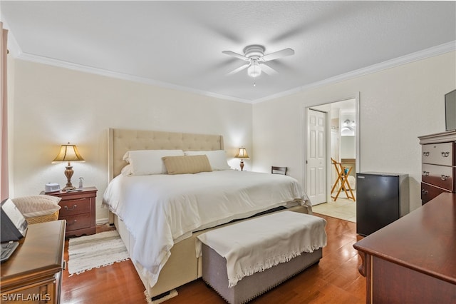 bedroom with crown molding, ceiling fan, and light hardwood / wood-style flooring