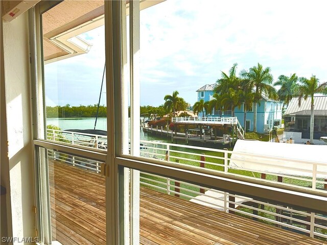 doorway to outside featuring a water view and a wealth of natural light