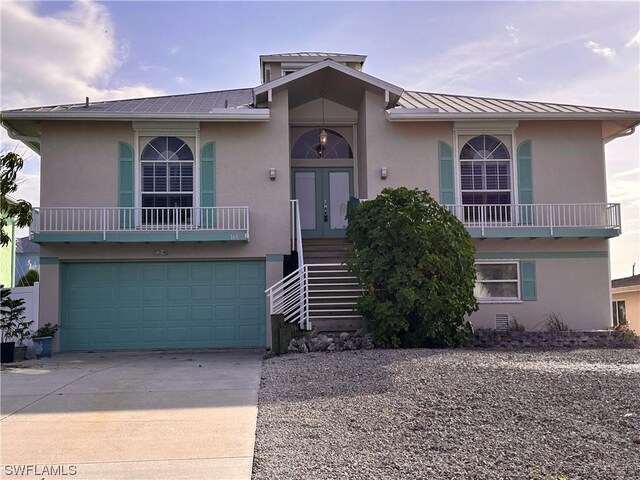 view of front of home with a garage and french doors