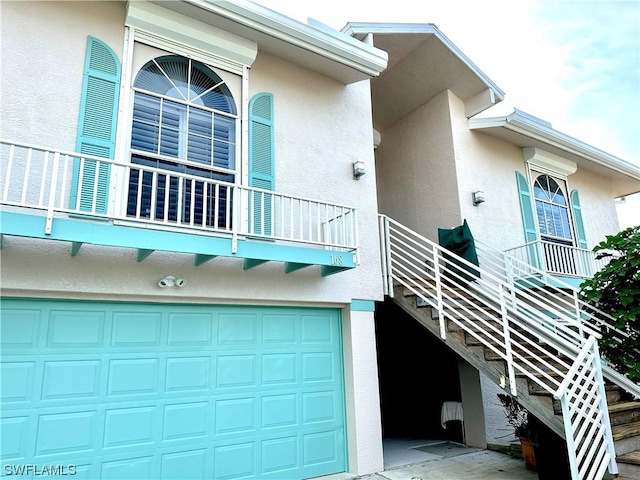 property entrance featuring driveway and stucco siding