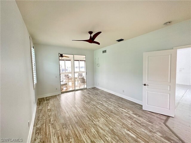 spare room with hardwood / wood-style flooring and ceiling fan