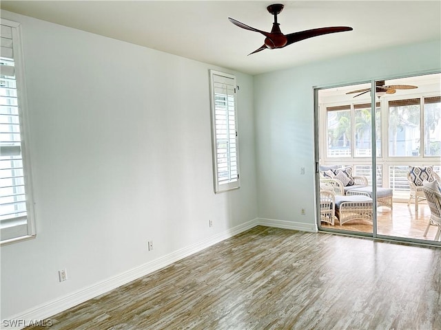 unfurnished room with ceiling fan, baseboards, and wood finished floors